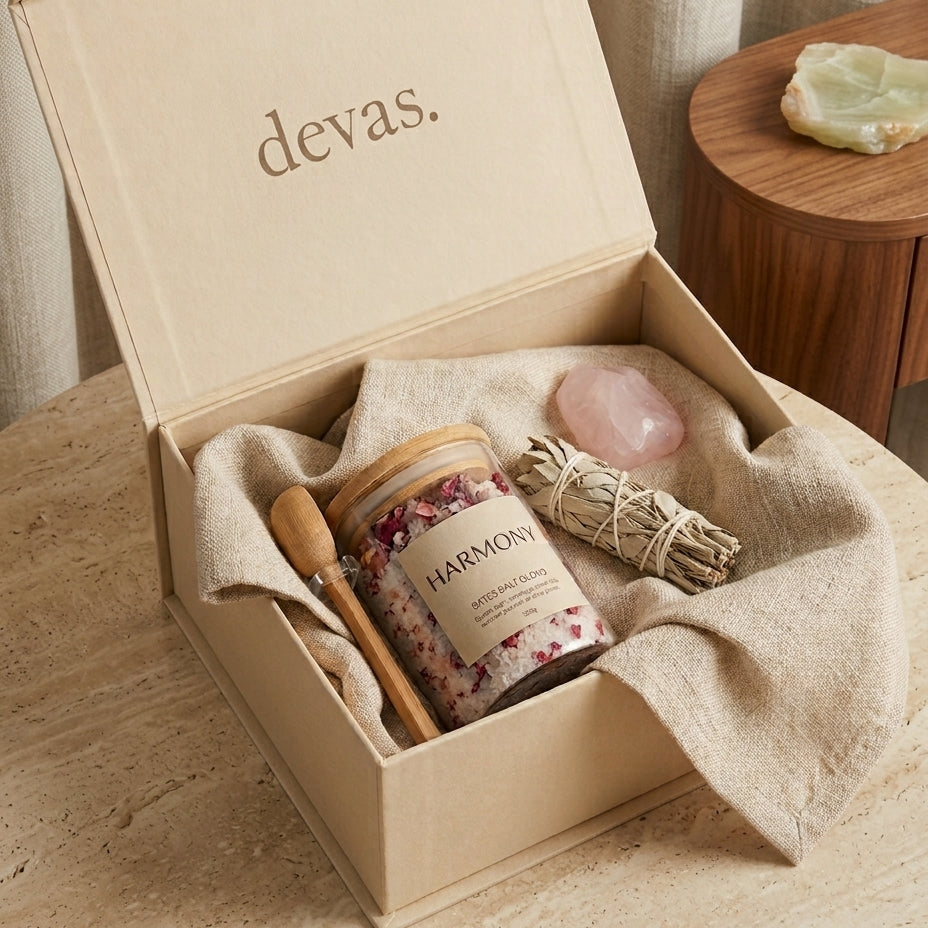 The Harmony Ritual Box by DEVA — open ivory gift box with bath salts, sage bundle, rose quartz and linen